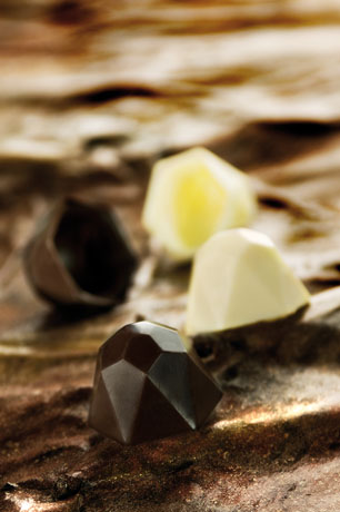 Cioccolatini artigianali: praline di cioccolato fondente, bianco e al limone. Dolciumi di lusso.