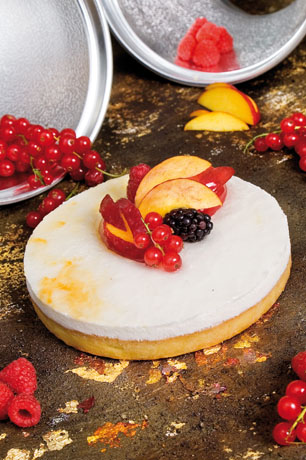 Torta moderna con frutta fresca. Dolce delizioso con pesche, lamponi e ribes.