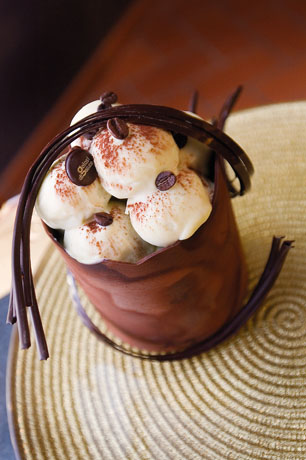 Dolce al cioccolato e caffè. Dessert goloso con crema, cacao e decorazioni di cioccolato. Pasticceria artigianale.