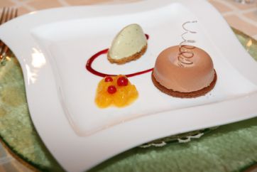 Dessert gourmet su piatto bianco: tarallo dolce, crema, frutta. Delizia culinaria.