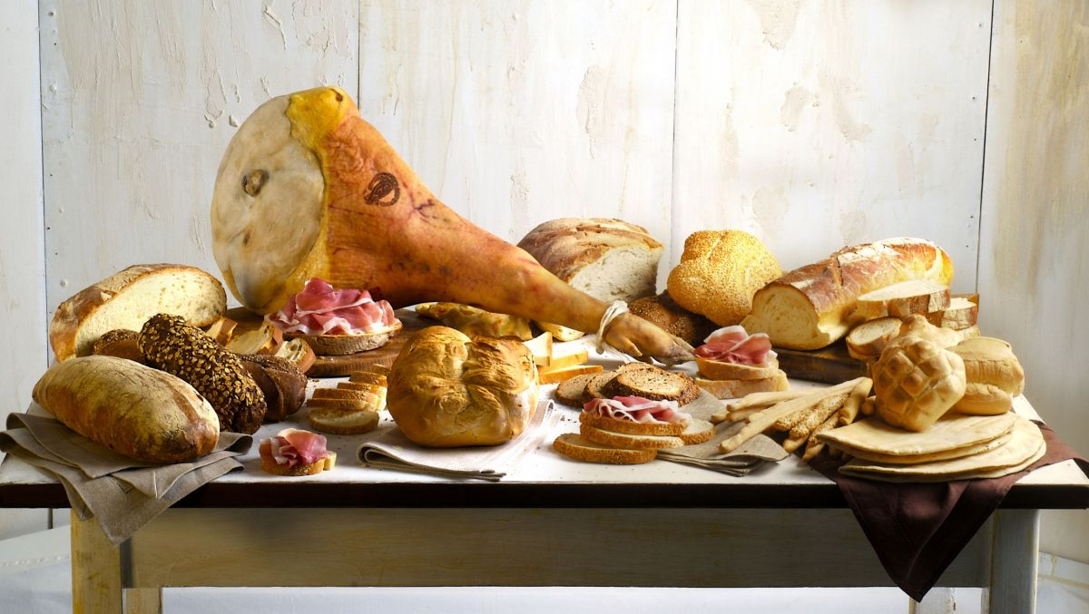 Prosciutto San Daniele DOP intero e pane artigianale italiano. Salumi e panificazione.