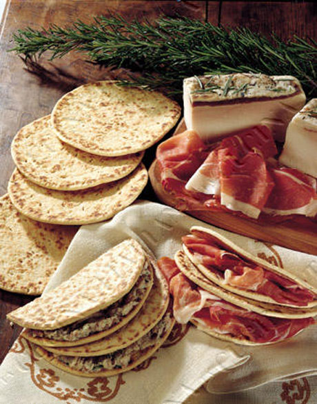 Piadina Romagnola IGP con salumi tipici. Specialità gastronomica dell'Emilia-Romagna.