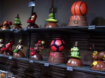Cioccolateria artistica a Montmartre: creazioni di cioccolato a forma di scarpe, rane, palloni e altri oggetti.