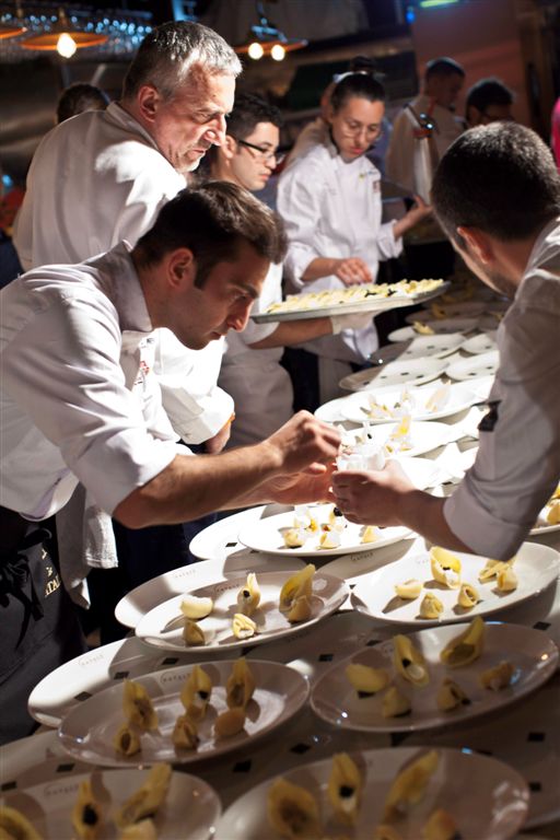 Chef all'opera. Cucina professionale, preparazione piatti gourmet. Ristorazione di alta qualità.