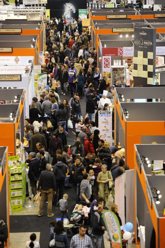Fiera affollata: stand gastronomici con persone. Evento food, prodotti tipici e degustazioni.