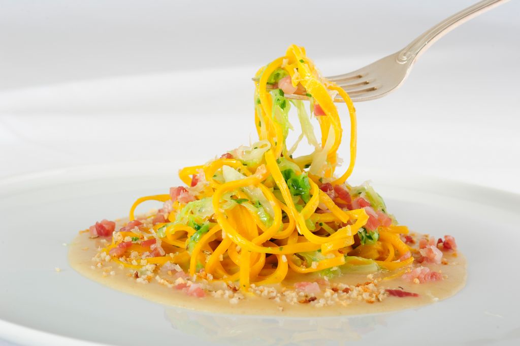 Spaghetti con speck e pane di segale. Primo piatto gourmet, cucina italiana.