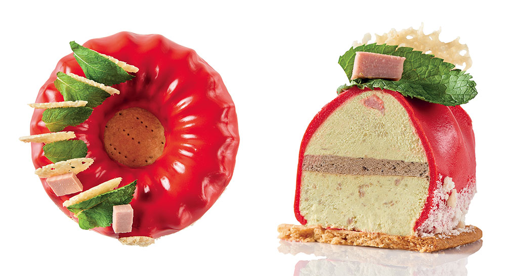 Dolce moderno: torta rossa glassata con menta e decorazioni. Sezione mostra strati di crema. Pasticceria creativa.