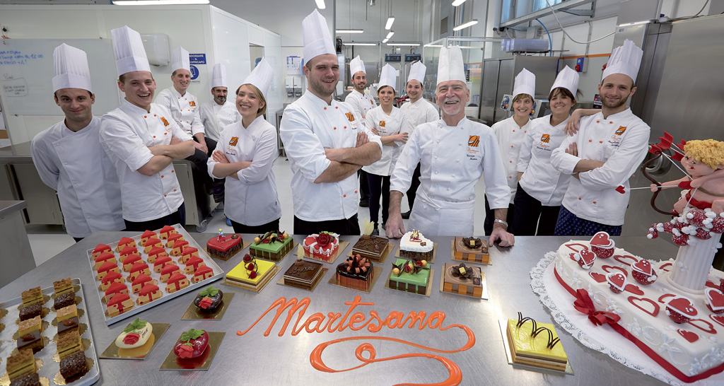 Team Martesana con torte e pasticcini artigianali. Chef pasticceri, alta pasticceria Milano.