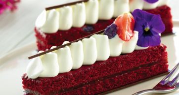 Red Velvet: torta elegante con panna, fragola e viola. Dessert delizioso.