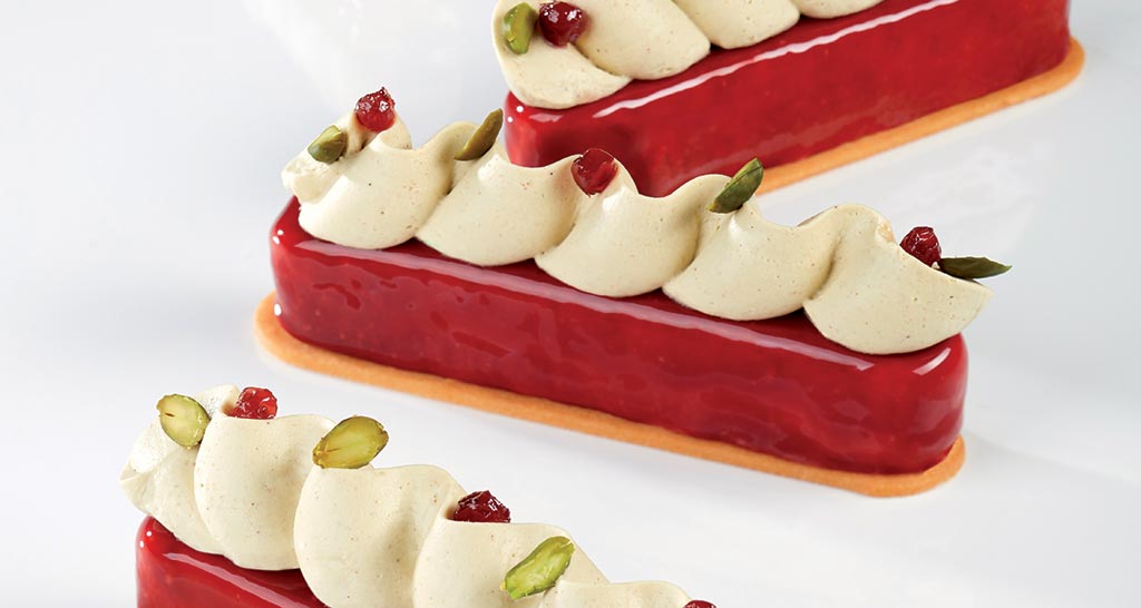 Semifreddo Lampini Crosara: dessert elegante con glassa rossa, crema e pistacchi. Pasticceria artigianale.