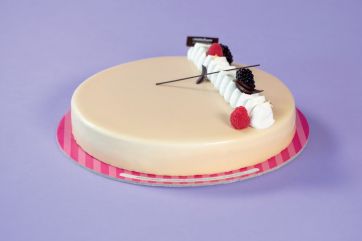 Torta elegante con glassa, panna e frutti di bosco. Pasticceria artigianale.
