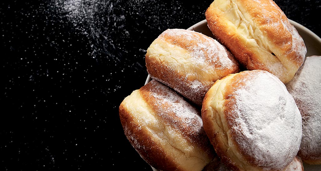 Bomboloni fritti con zucchero a velo. Dolci di Carnevale, ricetta golosa.