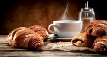 Croissant, pain au chocolat e caffè fumante. Colazione dolce italiana.