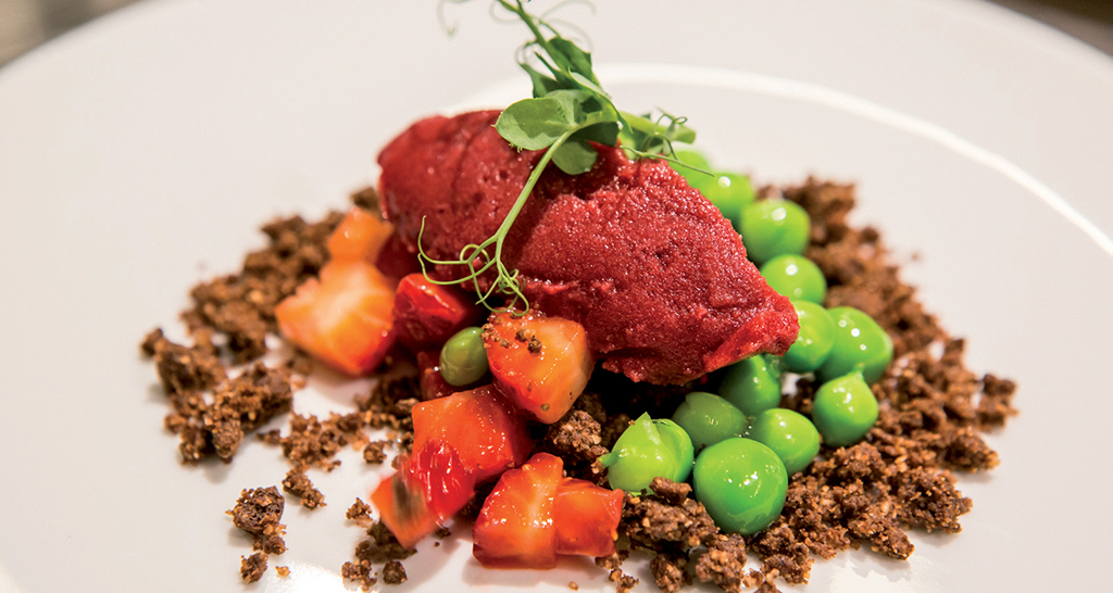 Dessert gourmet: sorbetto, fragole, piselli e crumble al cioccolato.