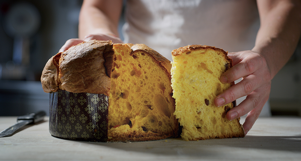 Panettone artigianale tagliato. Dolce tradizionale italiano con uvetta e canditi. Ideale per Natale e feste.