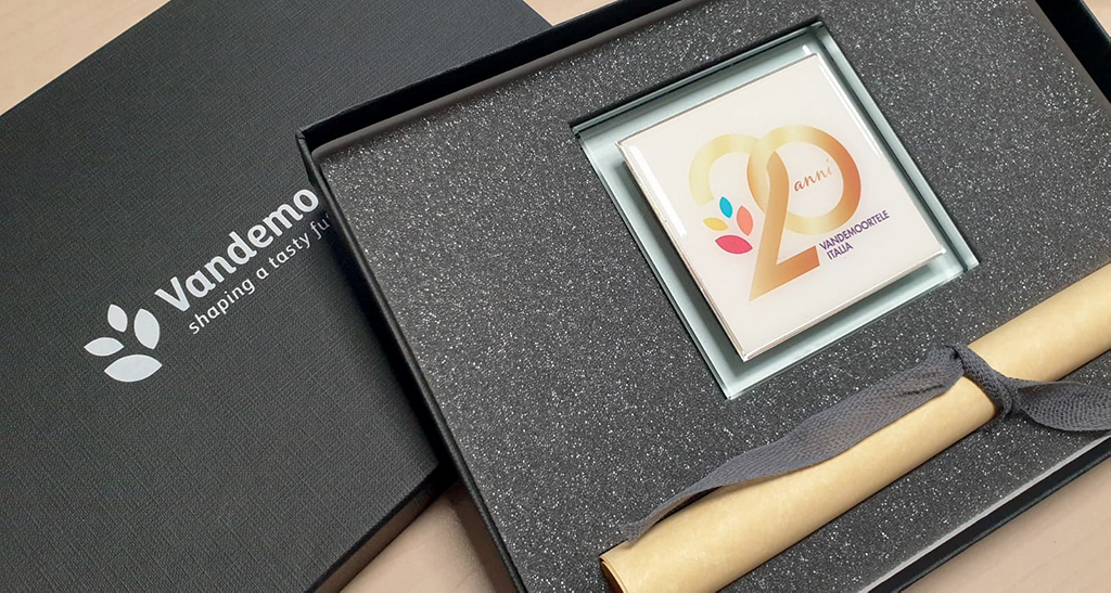 Cofanetto Vandemoortele Italia: 20 anni, pergamena e logo aziendale.