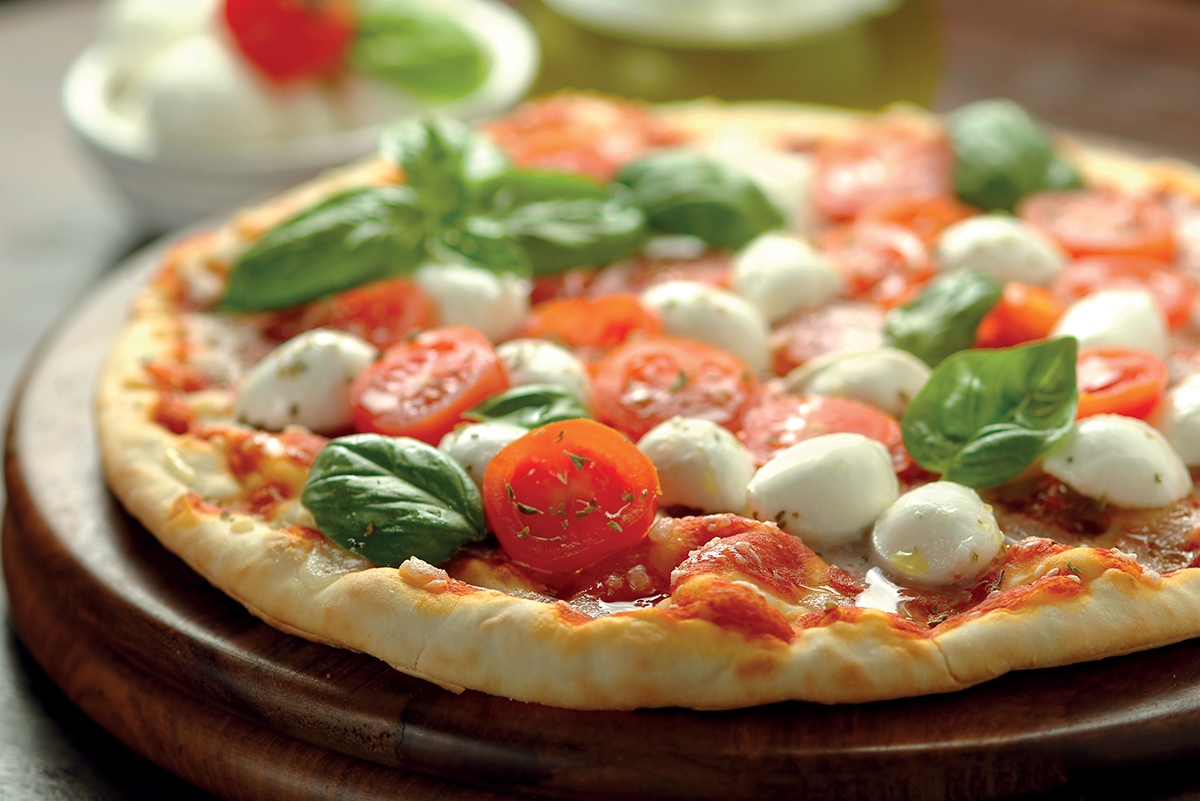 Pizza margherita con mozzarella, pomodorini e basilico fresco. Lievitazione lunga.