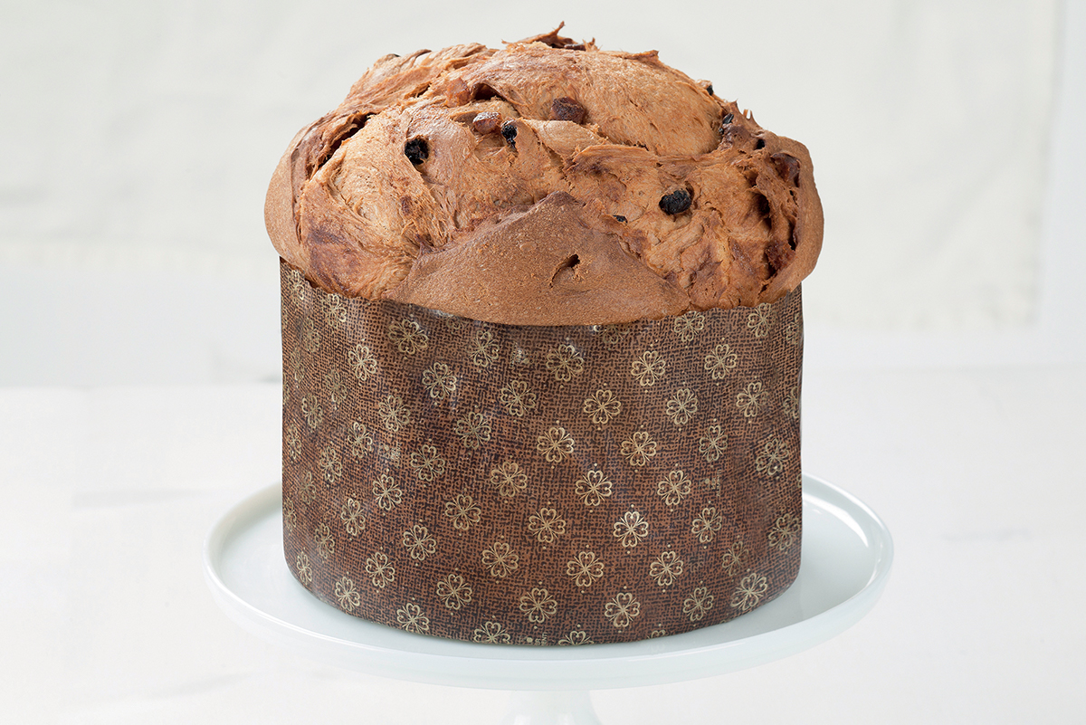 Panettone artigianale su piatto bianco. Dolce tipico di Natale.