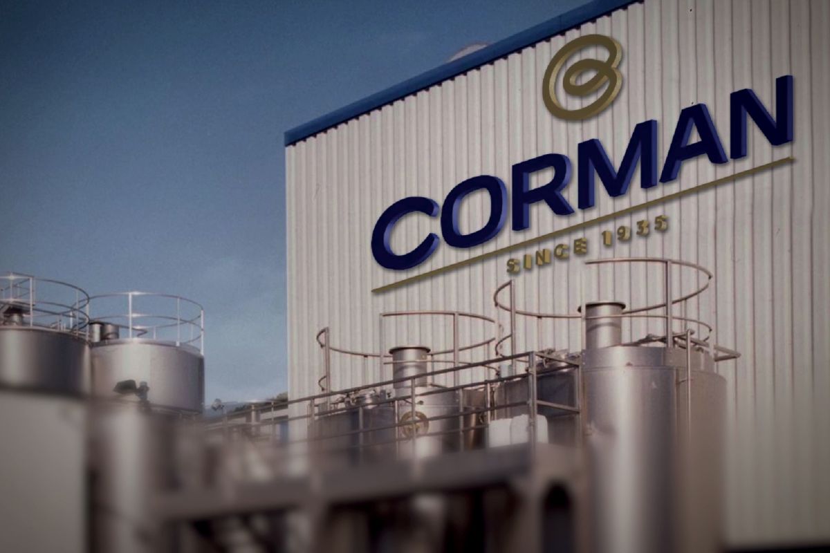 Stabilimento Corman per produzione burro. Logo Corman e silos industriali.