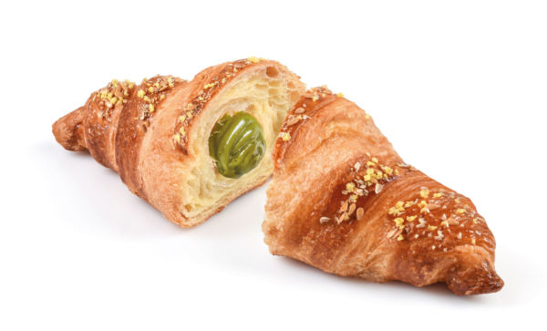 Croissant Rêver al pistacchio tagliato, ripieno di crema al pistacchio, pasticceria artigianale.